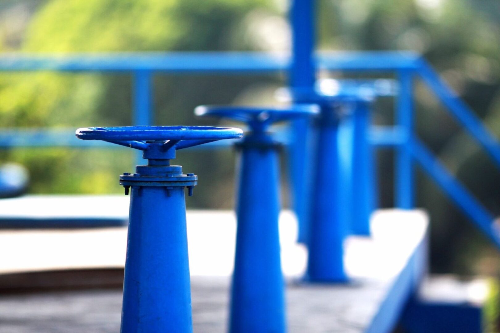 A row of blue poles sitting on top of a wooden deck.